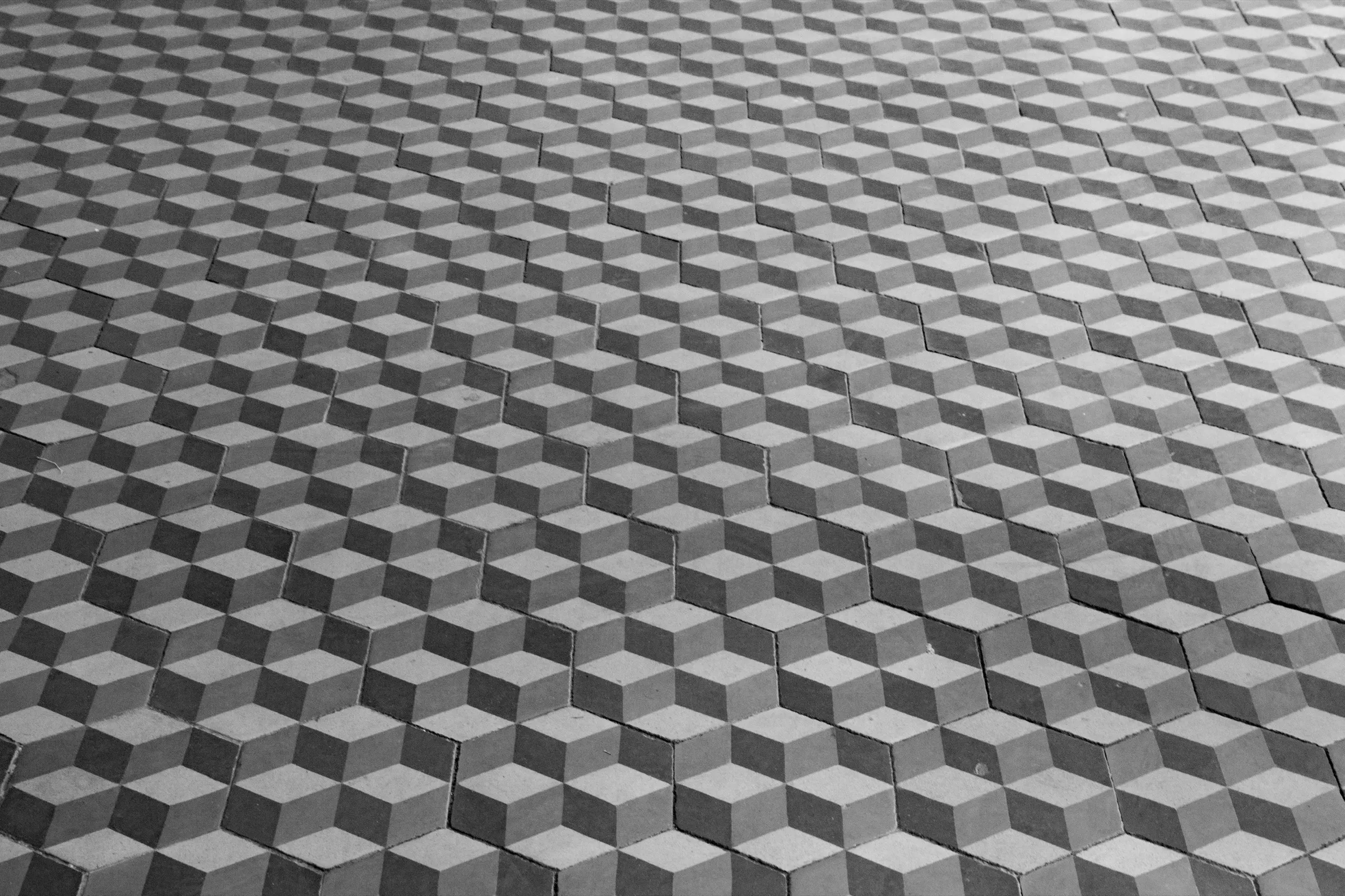 Hexagonal floor tiles arranged in a three-dimensional tumbling-block pattern