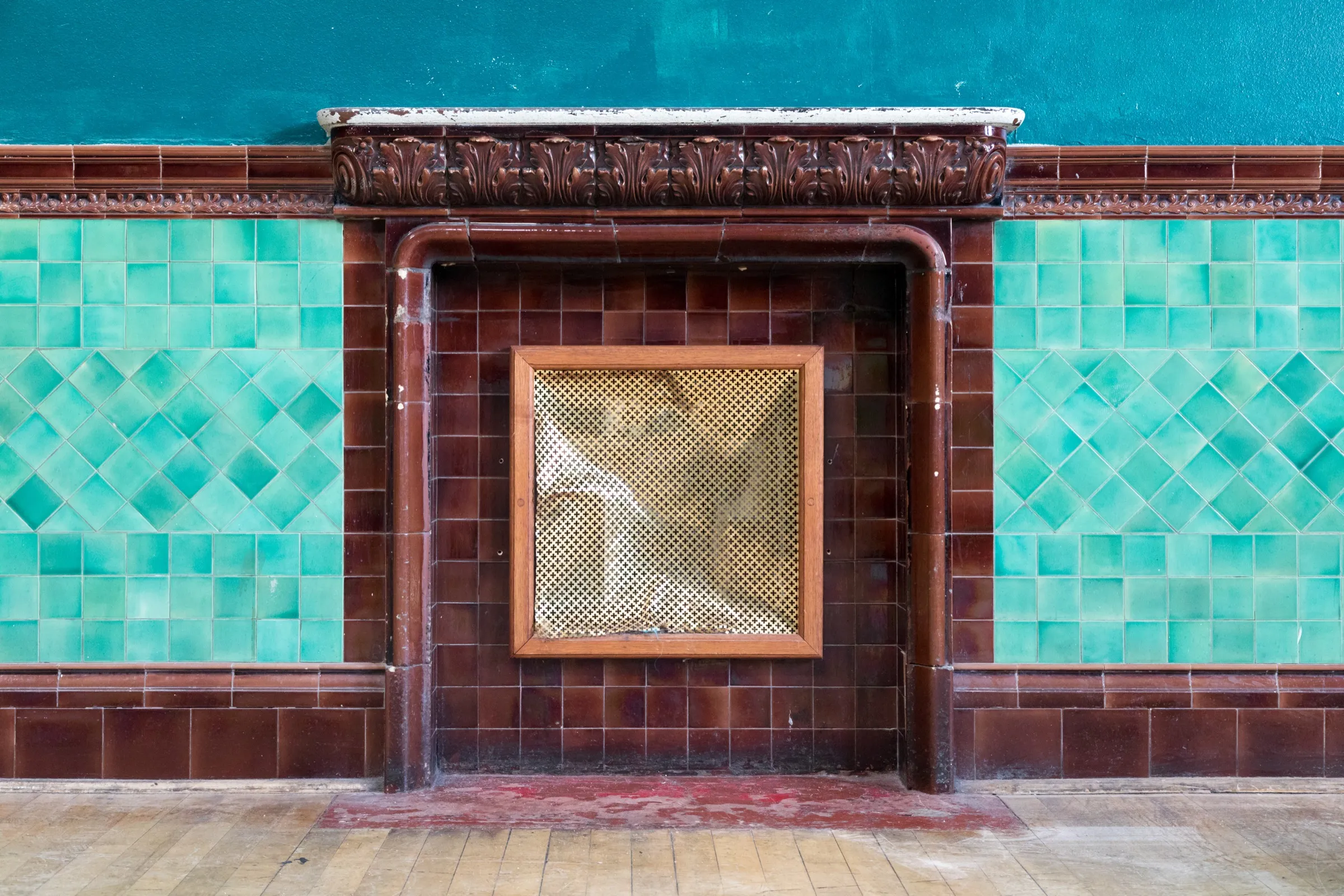 Victorian glazed-tile fireplace wall in teal and brown tile