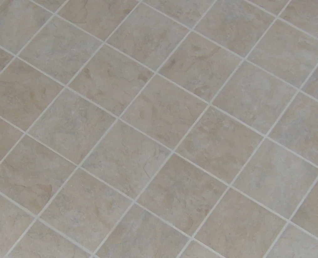 Stone-look porcelain floor tiles laid on a diagonal with crisp grout lines