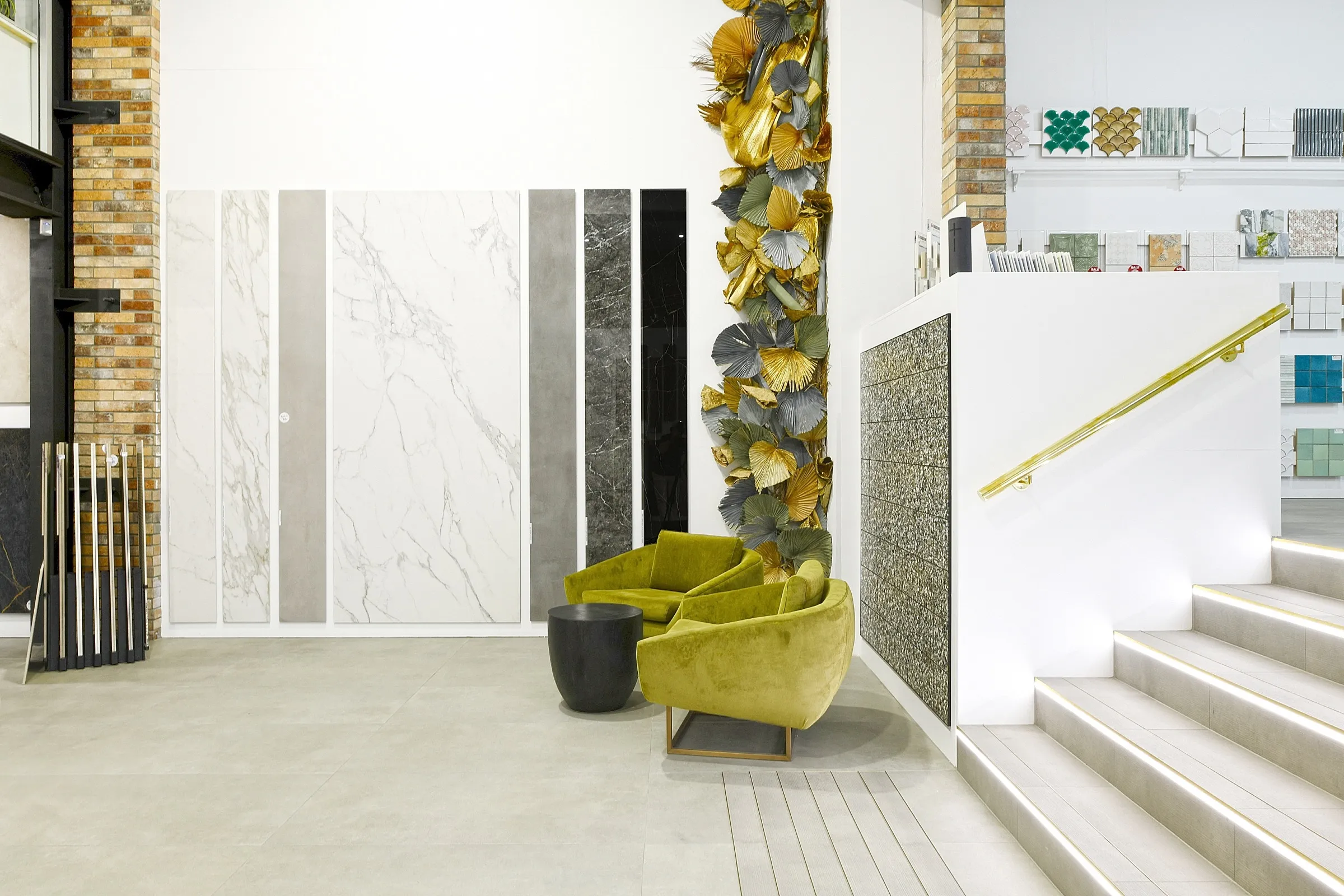 Styled tile showroom with large marble slab displays and sample boards